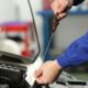 Mechanic checking car engine oil level